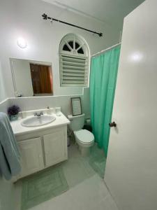 a bathroom with a sink and a toilet and a mirror at K2 Aqua Vista Escape in Ocho Rios