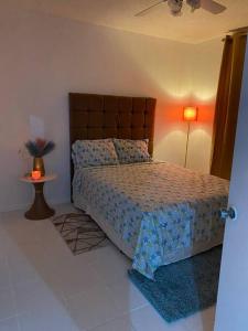 a bedroom with a bed and a table and a lamp at K2 Aqua Vista Escape in Ocho Rios