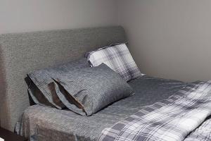 a bed with two pillows on top of it at Cozy 2-Bedroom Basement Guest Suite with Private Entrance and Proximity to the Airport in Edmonton