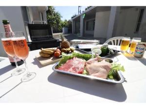 a table with a plate of food and a glass of beer at Shiraho Villa - Vacation STAY 13688v in Ishigaki Island