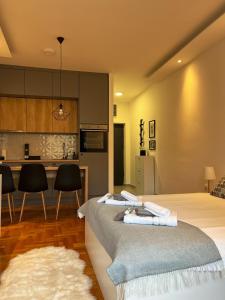 a bedroom with a bed and a kitchen with a counter at Apartman Malena in Trebinje +41 photos