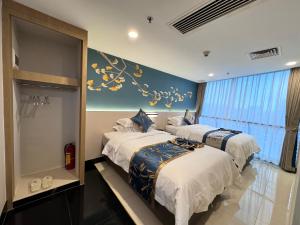 Ein Bett oder Betten in einem Zimmer der Unterkunft Yixuan Yasi Apartment-free shuttle during the Canton Fari