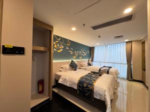 Ein Bett oder Betten in einem Zimmer der Unterkunft Yixuan Yasi Apartment-free shuttle during the Canton Fari