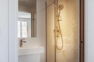 a bathroom with a shower and a sink at Le Mireille in Paris
