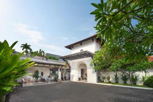 a large white house with a driveway at AmantraNa Canggu in Canggu
