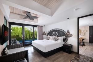 a bedroom with a bed and a living room at AmantraNa Canggu in Canggu