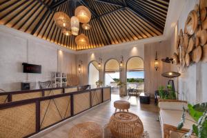 a lobby with a bar with a table and chairs at AmantraNa Canggu in Canggu