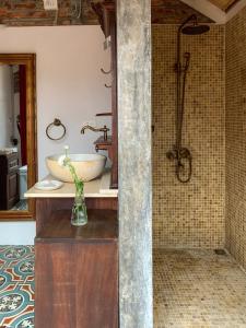 a bathroom with a sink and a counter with a vase at Zen Villa - Retreat Homestay in Bắc Ninh