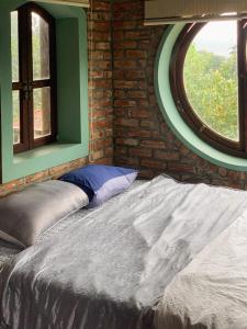 a bed sitting in a room with a window at Zen Villa - Retreat Homestay in Bắc Ninh