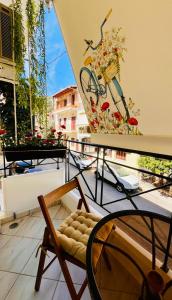 a chair on a balcony with a bike on the wall at Dreamy Luxury Studio in Nafpaktos
