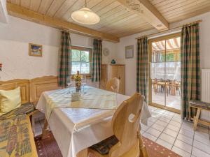 a dining room with a white table and chairs at Holiday home Sterl in Eppenschlag