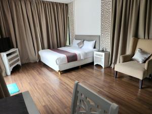 a hotel room with a bed and a chair at Jadin Villa at Nusa Dua Bali in Nusa Dua +23 photos