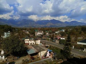 a view of a city with mountains in the background at Portola Hotel By Parkside in Dharamshala