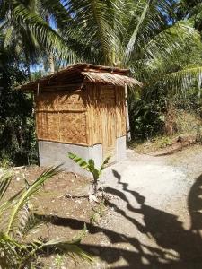 a small shack in the middle of a dirt road at Era's Garden Homestay in Catmon