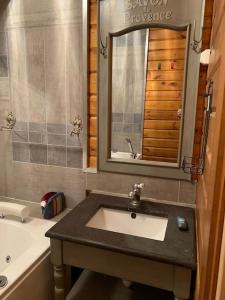 a bathroom with a sink and a bath tub at Beautiful *** Chalet Le Gentiane in L'Alpe du Grand Serre in La Morte