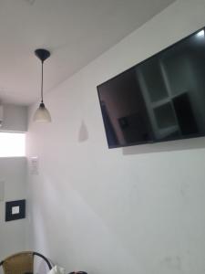 a flat screen tv hanging on a white wall at Confort 13-47 in Cali