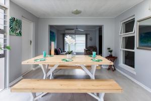 a dining room with a wooden table in a room at 17A Raven Street Vacation Home in Bloubergstrand