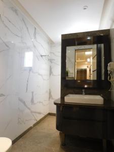 a bathroom with a sink and a mirror at Nature's Nest in New Delhi