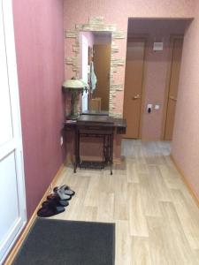 a hallway with a desk and a rug on the floor at Дизайнерская квартира с барной стойкой по Бозтаева in Semey