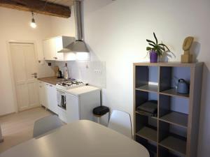 a kitchen with a table and a white stove top oven at Apartmán Sedlecká v centru Kutné Hory in Kutná Hora