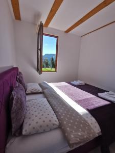 a bedroom with a large bed with a window at Brvnara Vidra in Pale