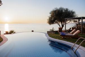 a swimming pool with a view of the ocean at Nisos Villa Emerald in Kornáta