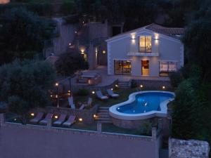 an aerial view of a house with a swimming pool at Nisos Villa Emerald in Kornáta