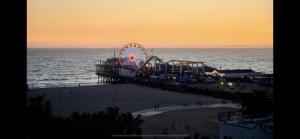 a ferris wheel on the beach at sunset at Lovely 2bedroom next to Santa Monica college in Los Angeles