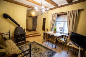 a living room with a table and a stove at Villa Hortensia in Tallinn