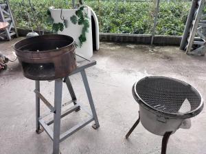 a pot and a grill sitting on a stand next to a grill at 埔里來趣窩窩莊園平價小包棟 in Puli