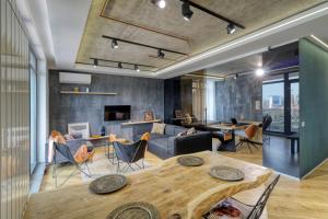 a living room with a couch and a table at Penthouse Floreasca in Bucharest