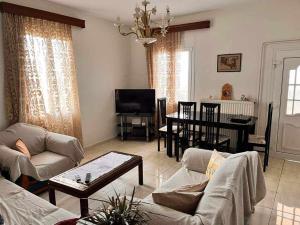 un soggiorno con divano e tavolo di Eliza Apartment Atheras a Athéras