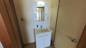 a bathroom with a sink and a mirror at HOTEL GREEN PLAZA SHODOSHIMA - Vacation STAY 51989v in Ikisue