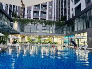 a person in a swimming pool in a building at Livahome - PDT Lux homestay Di An HCMC in Dĩ An