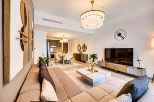 a living room with a couch and a tv at Pleasant new apartment in Dubai Creek Harbour in Dubai