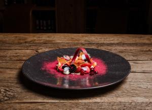 a plate of food on a wooden table at Kaiserhof Superior in Ellmau