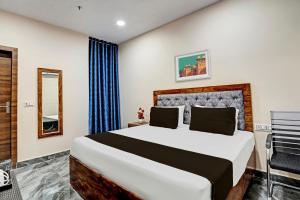 um quarto com uma cama grande num quarto em OYO Lord King Hotel em Nova Deli