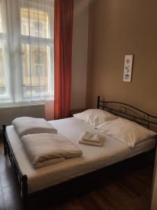 a bedroom with a bed with a tray on it at Sunfower Prague Suites in Prague