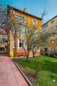 un edificio con un albero e una panchina di fronte ad esso di The Secret Spot 1BD Apartment a Sofia