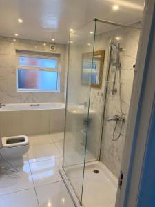 a bathroom with a shower and a toilet at The w3 flat in London