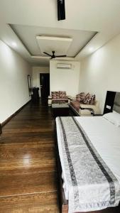 a hotel room with a bed and a couch at The God's Palace Resort in Meerut