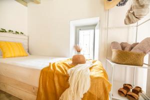 a bedroom with a bed with a hat on it at Opus apartment in Agios Stefanos