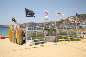 a beach with a surf shop on the beach at FarOut - BeachResort & Camping in Mylopotas