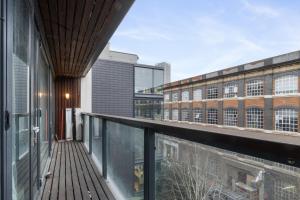 an open balcony with a view of a building at LiveStay - Modern Two Bed Apartment in Stratford in London