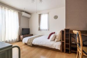 Ein Bett oder Betten in einem Zimmer der Unterkunft Felice Nishi-Shinjuku