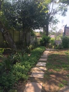 a path in a yard with trees and grass at 30 on Oatlands Road in Grahamstown