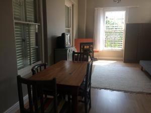 a dining room with a table and chairs and a window at 30 on Oatlands Road in Grahamstown