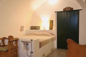 a bedroom with a bed and a green cabinet at Axion Studios in Aroniadika