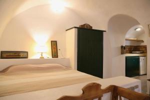 a bedroom with a green cabinet and a bed at Axion Studios in Aroniadika