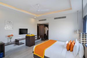 a hotel room with a bed and a television at Zone Connect by The Park,Udaipur in Udaipur